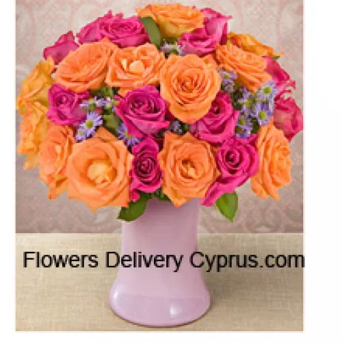 12 Pink And 12 Orange Roses With Seasonal Fillers In A Glass Vase